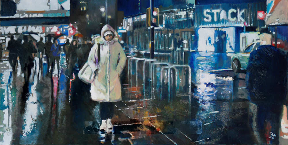 A woman in a raincoat walks past an intersection in the nighttime rain