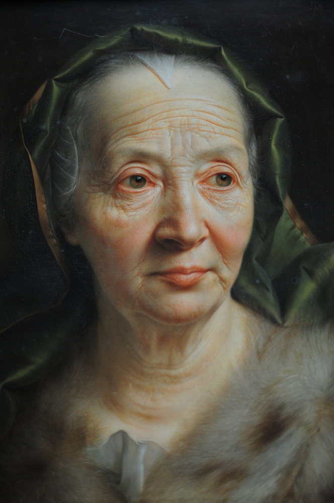 A haunting, ghostly portrait of an old woman with a green scarf