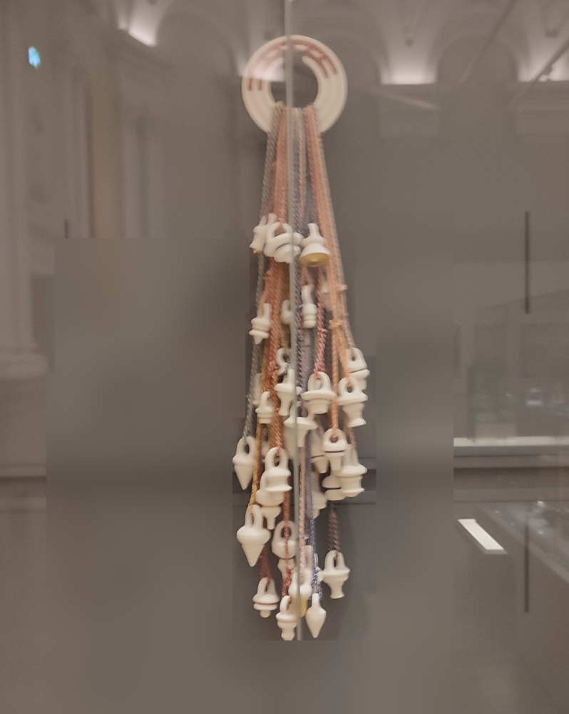 A collection of tea stoppers, hung on ropes in such a way that they really quite resemble a dreamcatcher made of buttplugs