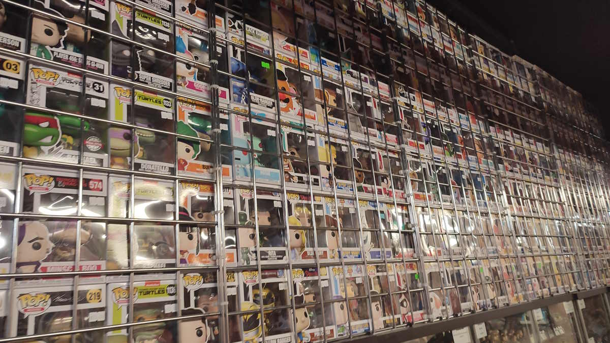 A wall stocked full of funko pop vinyls