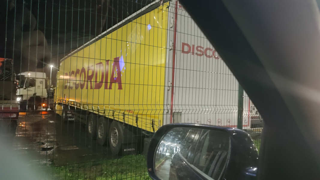 A parked lorry, late at night, bearing the name "Discordia" on its side.