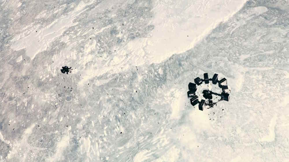 A shuttle and a destroyed spacecraft framed in shadow against an ice-white planet