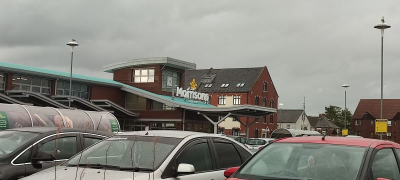 Cars parked in front of a Morrisons store.