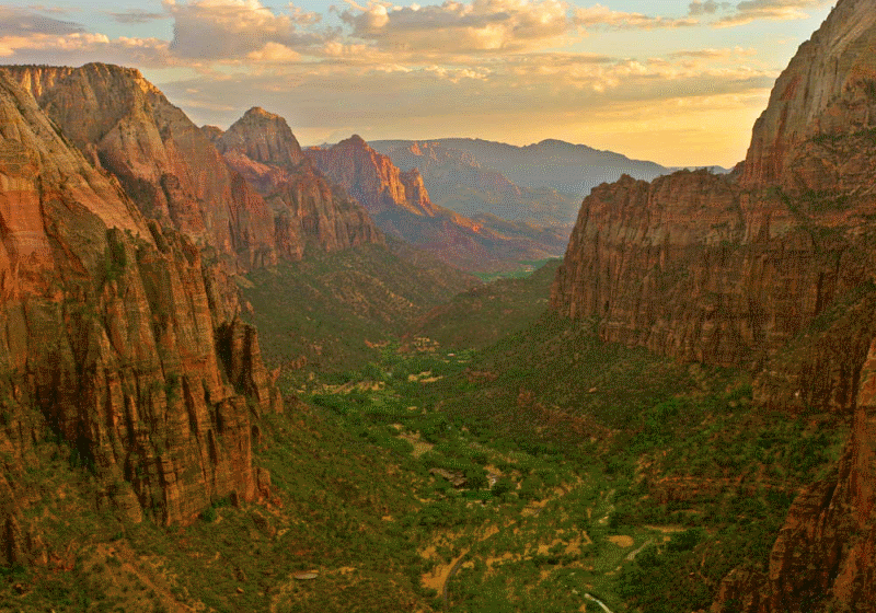 A verdant canyon between rocky cliffs.